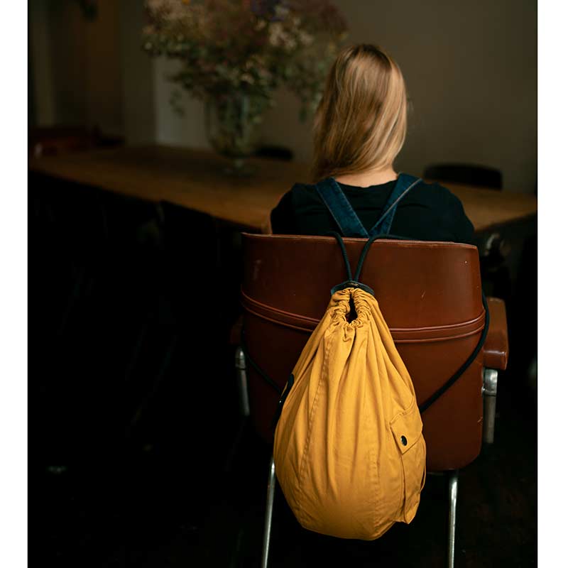 Helmet Bag yellow mustard chair